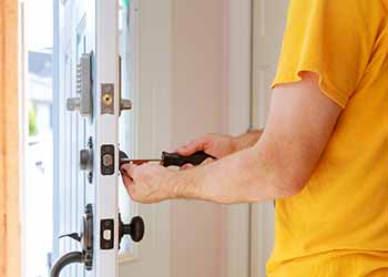 Worker installing or repairing new lock